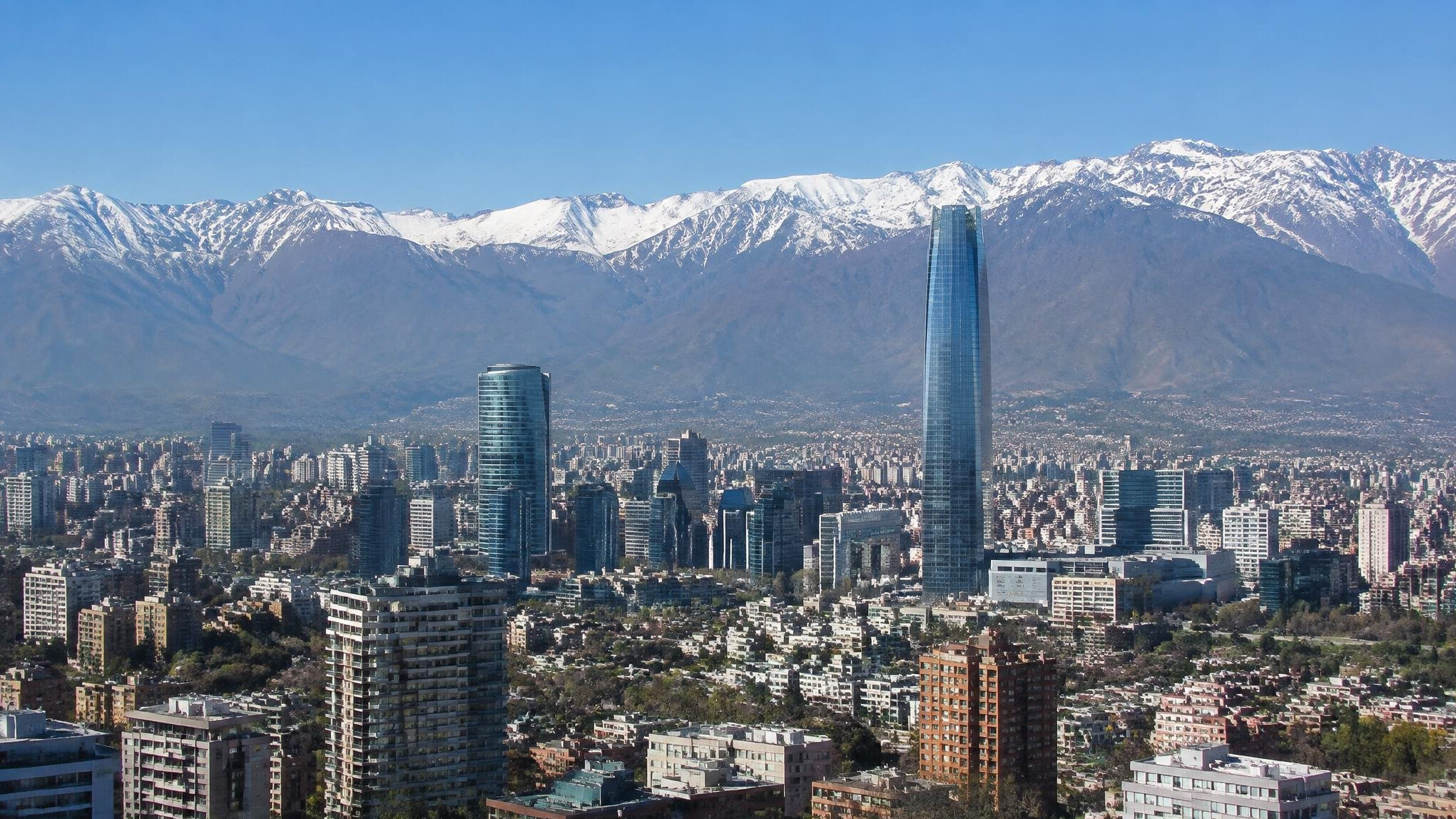 Wide view of a Chilean city skyline with mountains in the background