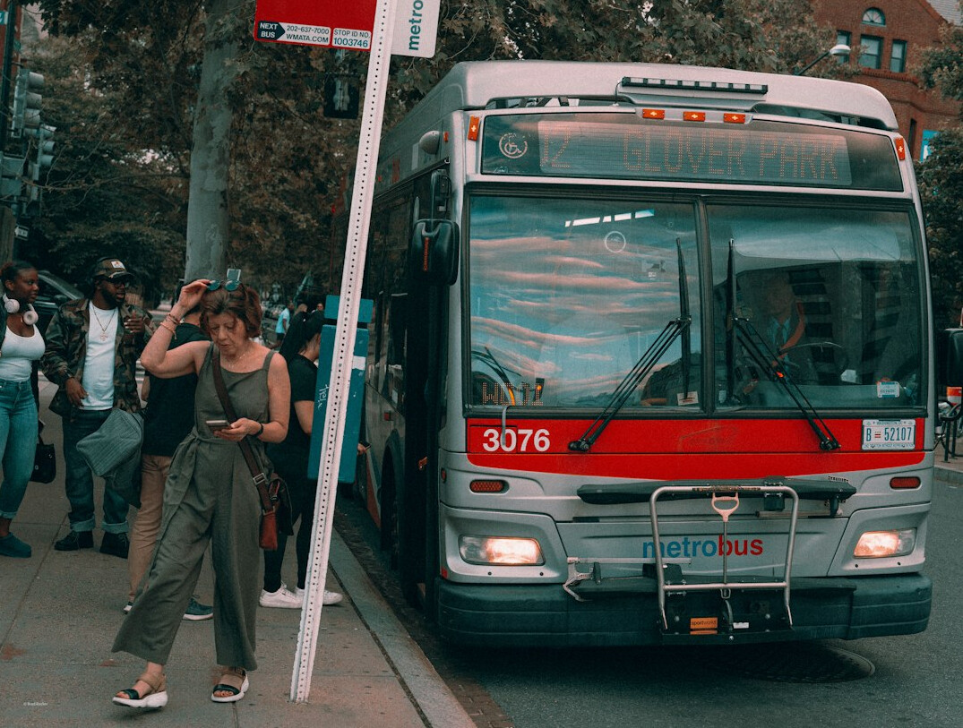 Passengers boarding a public city bus at a street stop